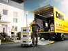 Umzugsprofi von J. & G. Adrian mit Umzugskisten vor Adrian-LKW und Wohnhaus